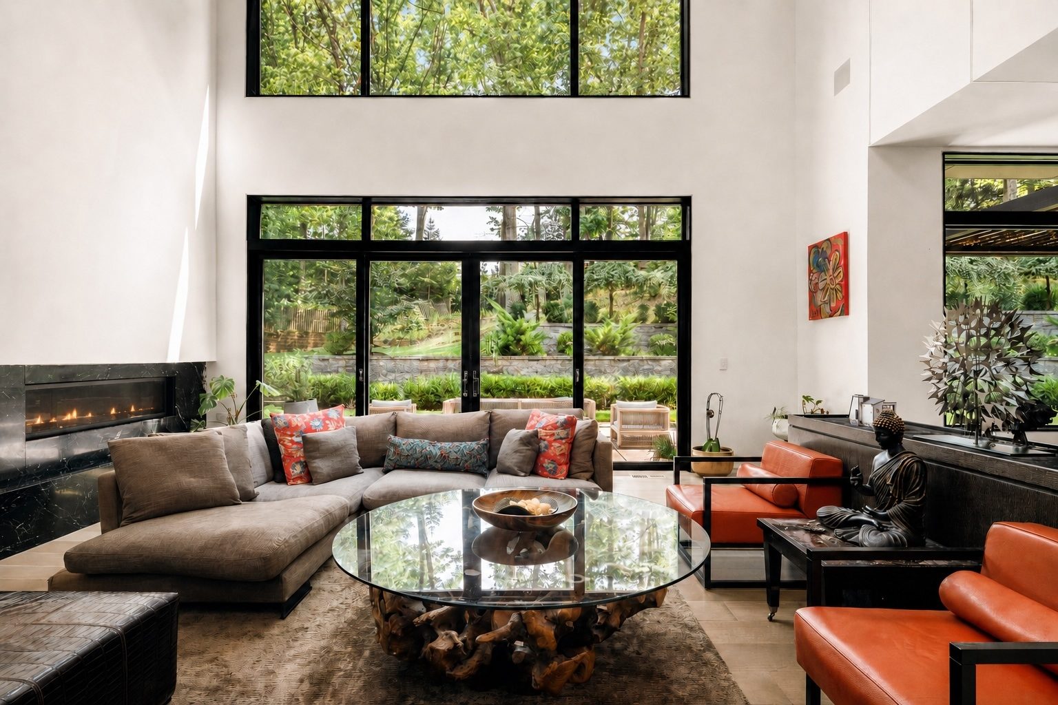double-height family room at 15 Seminole Way with a black marble linear fireplace and a wall of sliding glass
